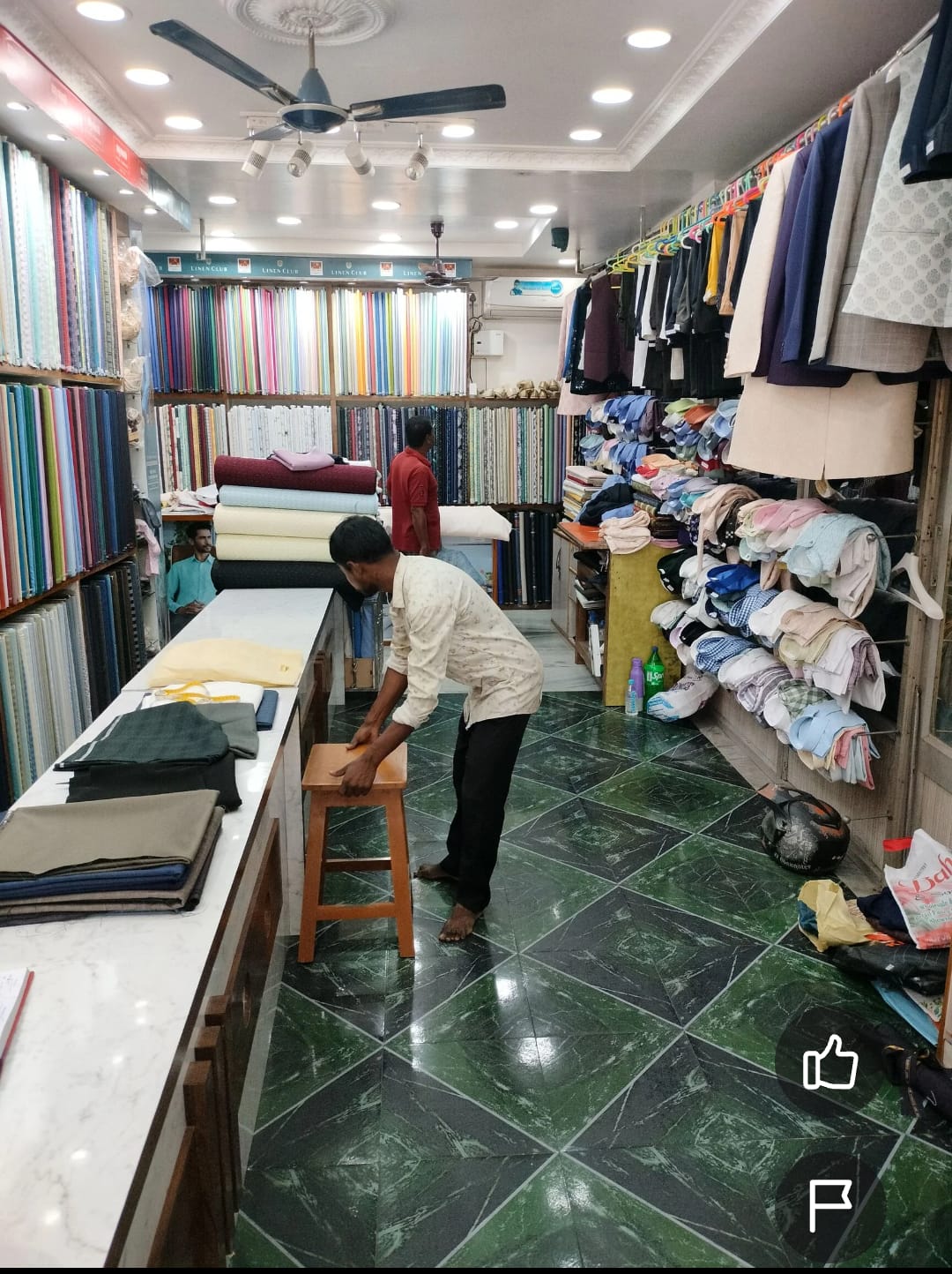 Inside New Prince Tailor & Cloth — fabric wall and workshop