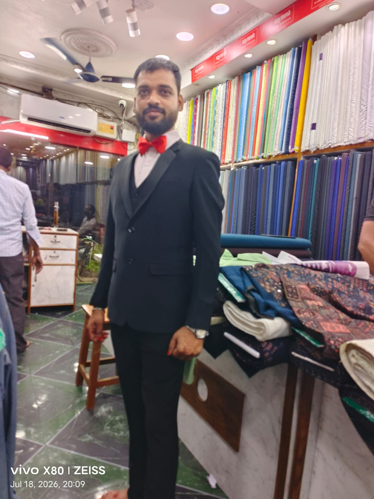 Black tuxedo with red bow tie